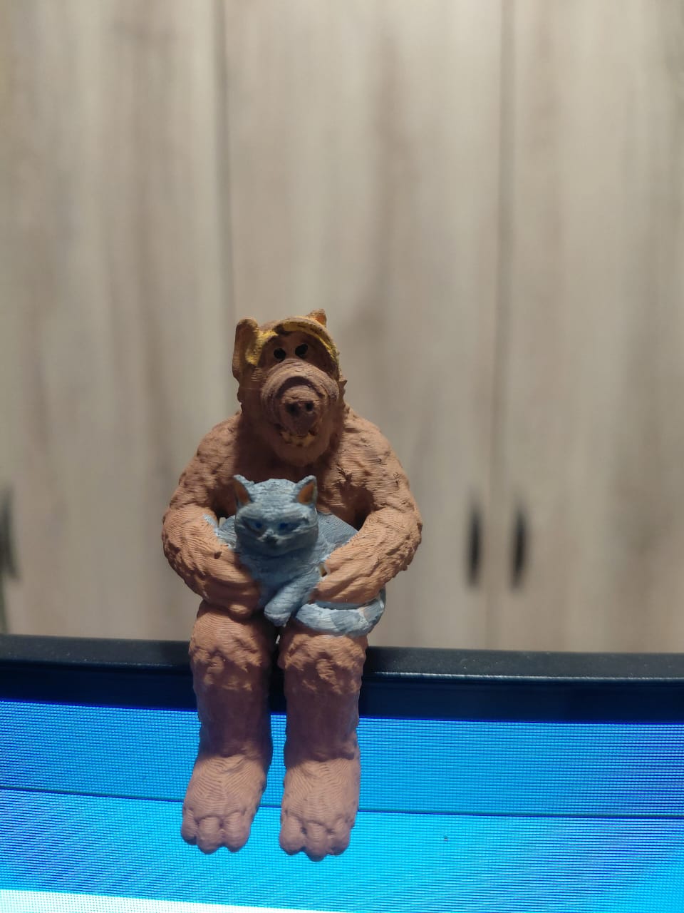 ALF figurine holding a cat.