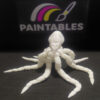 A white 3D printed articulated octopus model with its eight legs curved in various directions. The high-angle shot showcases the intricate joints of the tentacles and the smooth matte finish of the head, set against a black background.