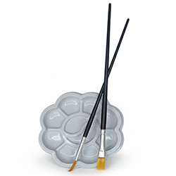 Paint brushes resting on a grey palette.