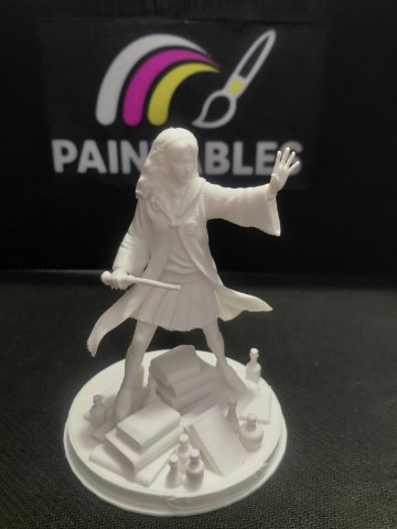 A white, unpainted 3D-printed miniature of Hermione Granger in a dynamic pose with her wand drawn, standing on a circular base cluttered with stacks of books and potion bottles, set against a black "Paintables" background.